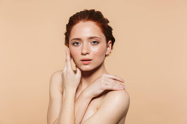 Amazing young redhead woman posing isolated over beige wall background. - Foto, afbeelding