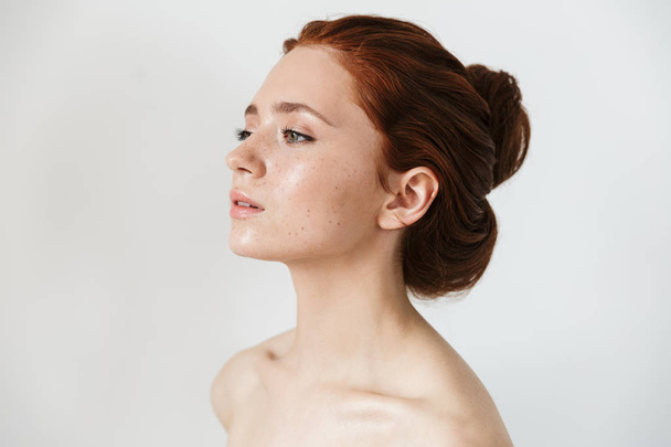 Young redhead woman posing isolated over white wall background. - Photo, image