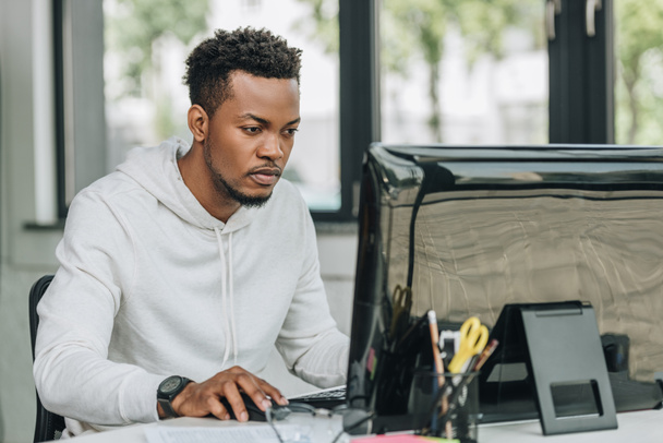 figyelmes afroamerikai programozó dolgozik számítógépen hivatalban - Fotó, kép