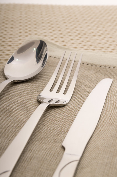 Knife, fork and spoon with linen serviette - Fotoğraf, Görsel