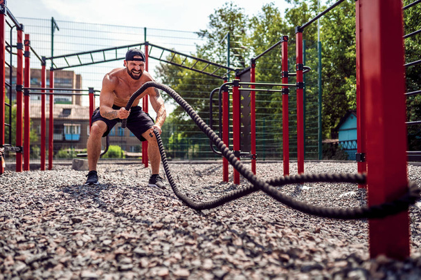 Men work hard with rope, functional training - Fotoğraf, Görsel