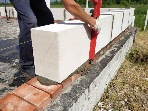 Start of construction in a new building with a free plan of red brick and gas-silicate blocks. - Photo, Image