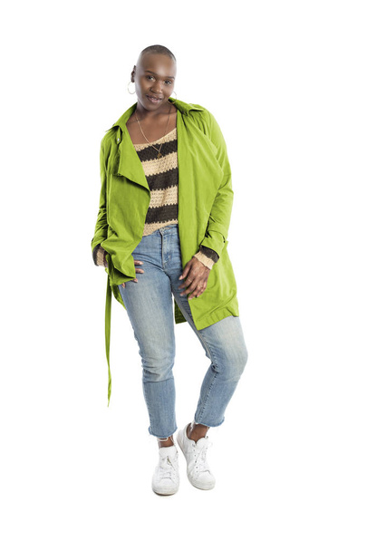 Black African American fashion model with bald hairstyle confidently posing with a vibrant lime green colored jacket for fall collection.  Depicts fashion design and clothing apparel - Fotó, kép