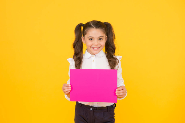 Upcoming event. Look here. Girl school uniform hold poster. Schoolgirl hold poster copy space. News information promotion. Changes coming. Back to school concept. Schoolgirl pupil show poster - Fotoğraf, Görsel