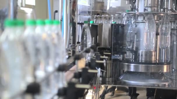 The finished bottle of water leaves the bottling line and moves automatically - Footage, Video