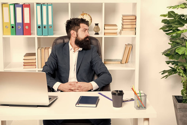 Office staff concept. Businessman in charge of business solutions. Developing business strategy. Risky business. Man bearded boss sit with laptop. Manager solving business problems. Office routine - Фото, изображение