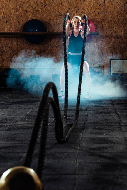 Γυμναστική γυναίκα πετώντας σχοινιά στο γυμναστήριο - Φωτογραφία, εικόνα