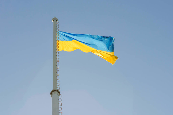 Narodowa flaga Ukrainy leci w błękitnym niebie. Żółta niebieska flaga Państwowa Ukrainy. Dzień Niepodległości. Konstytucji. Święto Narodowe - Zdjęcie, obraz