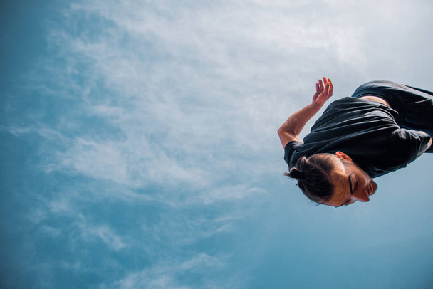Free runner make parkour backflip in the air - Photo, Image