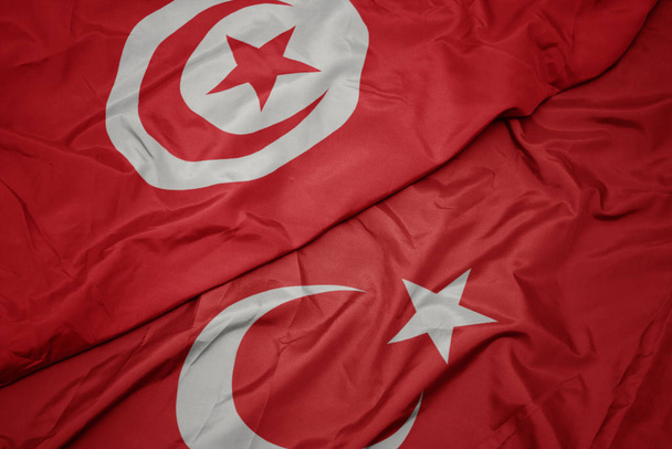 mávající barevná vlajka Turecka a národní vlajky Tuniska. - Fotografie, Obrázek