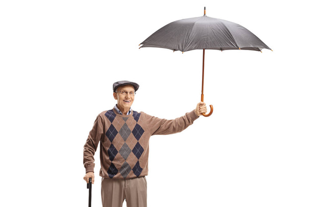 Elderly man with an umbrella  - Fotoğraf, Görsel