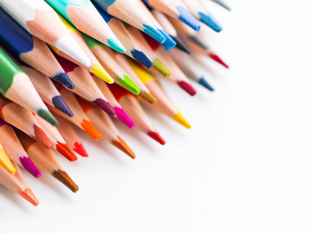 Row of colorful watercolor pencils on white background. School supplies. Kid's stationery with copy space. Back to school backdrop. - Foto, Imagen