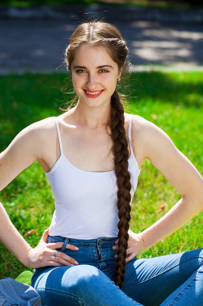 Portrait of a young beautiful brunette woman in on summer park b - Photo, image