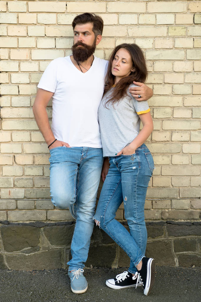 Couple in love. Family couple hugging on brick wall background. Bearded man and sexy woman cuddling. Sensual couple together. Family day. Careful hug of loving people. Just hang out together - Фото, изображение