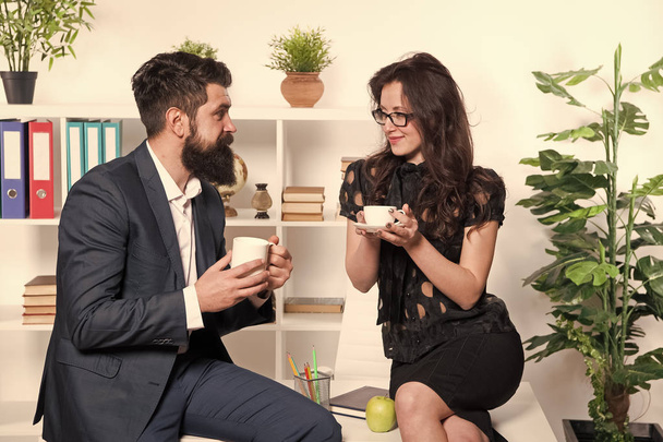 Man and woman pleasant conversation during coffee break. Discussing office rumors. Ask for recommendations. Coffee time to relax. Couple coworkers relax with coffee. Coffee break with colleague - Fotó, kép