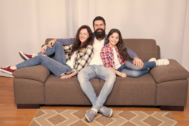 Back to our roots. Childrens day. Little girl love her parents at home. Happy family. Father, mother and little girl child at home. Family day. Bearded man and woman with little girl daughter - 写真・画像