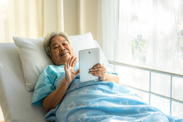 Asian senior using a digital touch screen tablet, she is connect - Fotoğraf, Görsel
