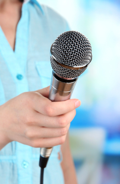 Female with microphone on room background - Foto, Bild