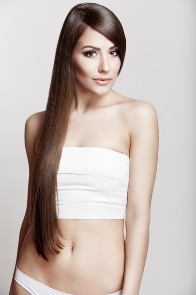 Beautiful young brunette woman with long hair - Фото, изображение