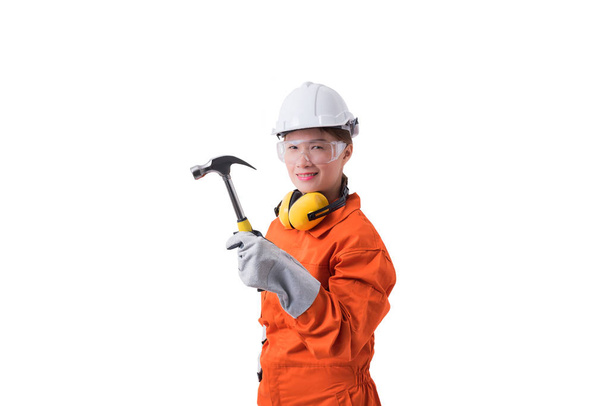 portrait of a woman worker in Mechanic Jumpsuit is holding hamme - Zdjęcie, obraz