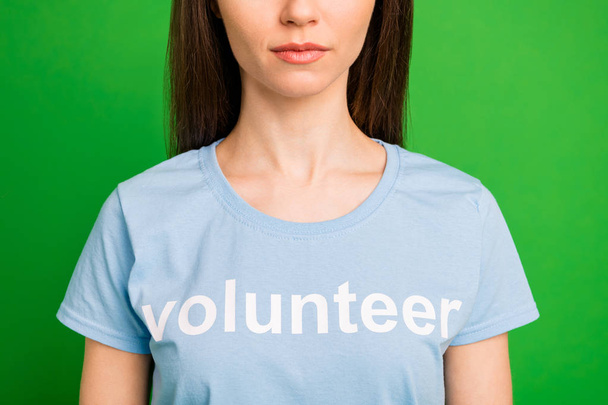 Cropped close-up portrait of nice attractive lovely candid calm straight-haired girl wearing printed cotton tshirt worldwide peace organization isolated over bright vivid shine green lime background - 写真・画像