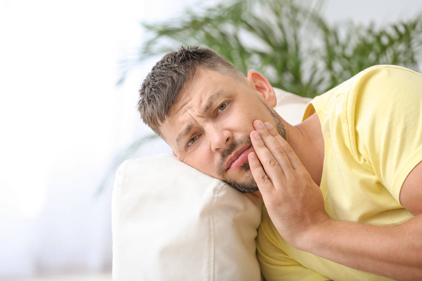 Man suffering from toothache at home - Foto, immagini