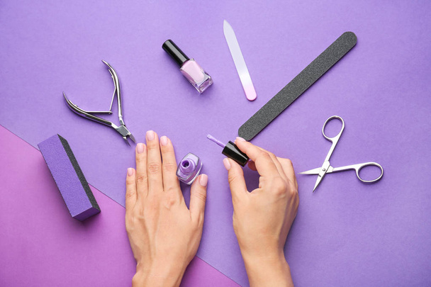 Female hands with supplies for manicure on color background - Photo, Image