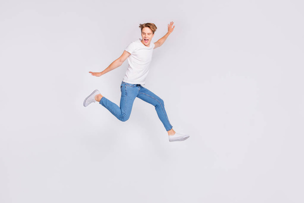 Full body profile photo of jumping high guy feel himself lightweight wear casual outfit isolated white background - Foto, Bild