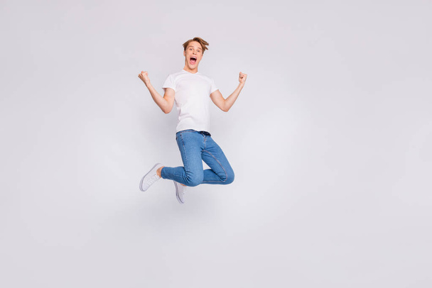 Full length photo of jumping high guy wear casual outfit isolated white background - Foto, Imagem