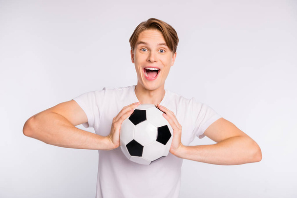 Photo of attractive guy holding big playing ball cheering favorite team wear casual outfit isolated white background - Foto, afbeelding