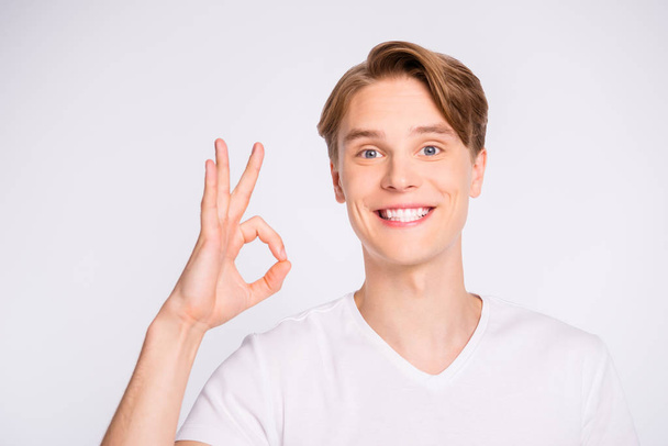 Close-up portrait of his he nice cute attractive cheerful cheery glad content guy showing ok-sign isolated over light white pastel background - Foto, imagen