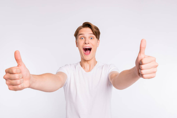 Portrait of his he nice cute attractive cheerful cheery glad excited guy giving two double thumbup isolated over light white pastel background - Foto, Bild
