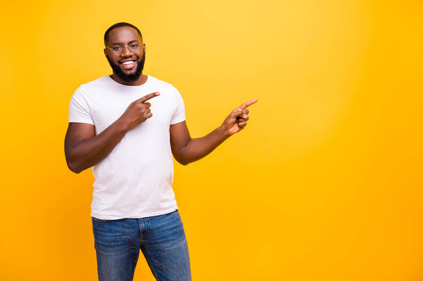 Photo of confident cheerful black person pointing at yellow background he has been isolated with - Zdjęcie, obraz