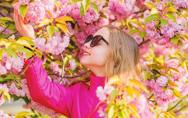 summer holiday. Childhood beauty. skincare. Natural cosmetics for skin. blossom smell, allergy. small girl in spring flower bloom. happy girl in cherry flower. Sakura tree blooming. Summer happiness - Fotografie, Obrázek