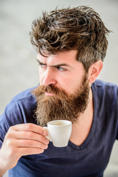 Enjoy hot drink. Hipster drinking fresh brewed coffee. Man with beard and mustache and espresso cup. Bearded guy consume caffeine. Espresso arabica only. Coffee break concept. Guy relaxing espresso - Фото, зображення