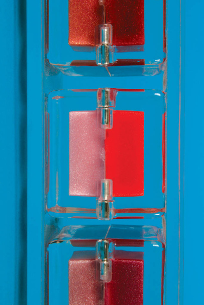 Red and pink powder on blue background. - Photo, Image