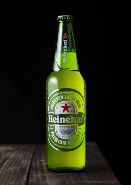 LONDON, UK - APRIL 27, 2018: Bottle of Heineken Lager Beer on dark wooden background. - Photo, image