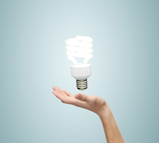 hand pand energy saving lamp - Фото, изображение
