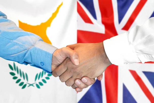 Handshake on Cyprus and UK flag background. - Фото, изображение