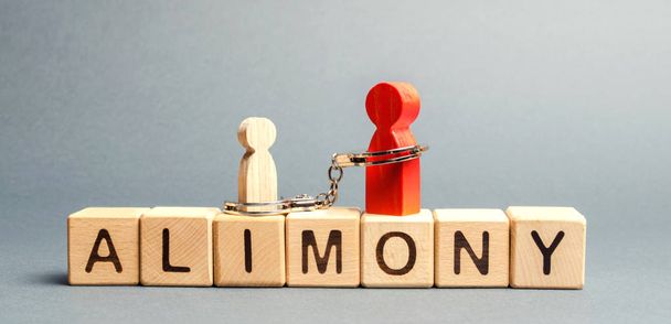 The parent is handcuffed to the child and the word alimony. The concept of parental debt. Alimony payment. Custody, care and maintenance of minor children. Responsibilities in the family. Family code. - Photo, image