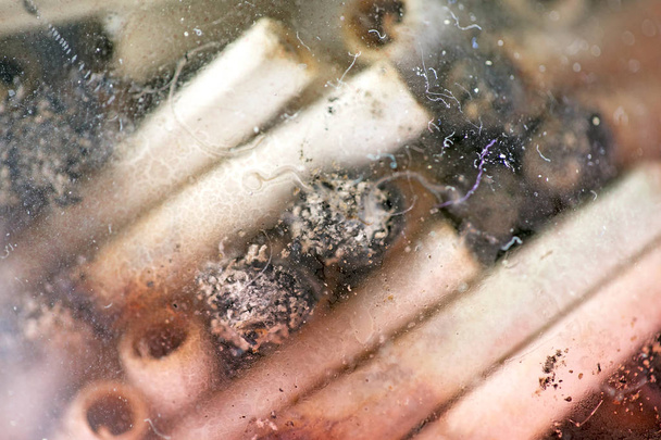 Ashes and joins from medical cannabis in glass macro background  - Photo, Image