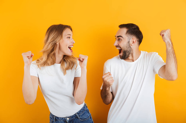 Portrait of positive pleased couple man and woman in basic t-shi - Photo, Image