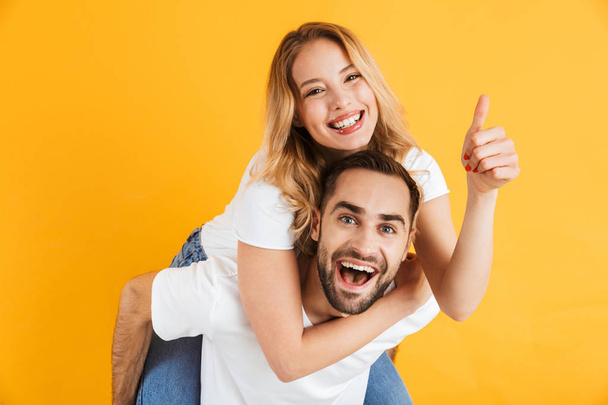 Excited cheerful young couple standing isolated - Foto, Bild