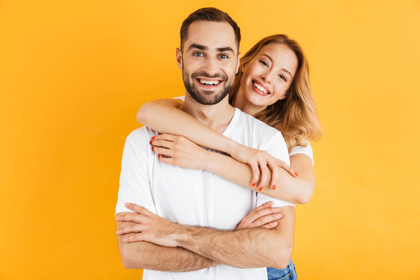 Excited cheerful young couple standing isolated - Foto, imagen