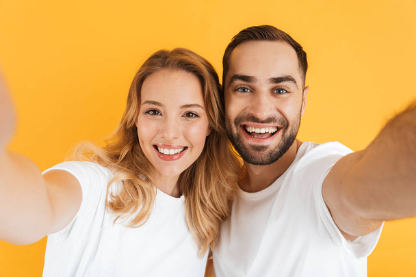 Excited cheerful young couple standing isolated - Photo, Image