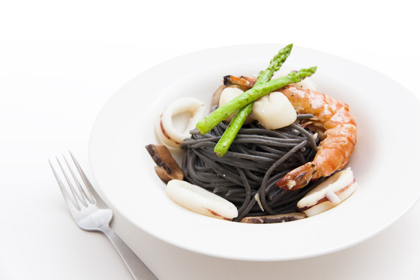 Black spaghetti with seafood on white background (squid ink past - Foto, Imagem