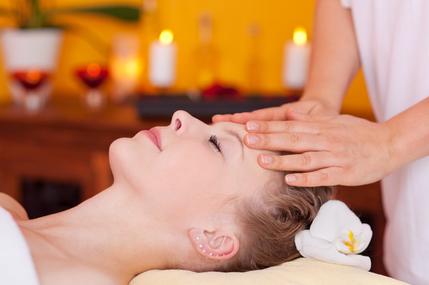 Closeup of young woman receiving head massage - Fotó, kép