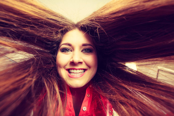Happy positive woman with long brown hair - 写真・画像
