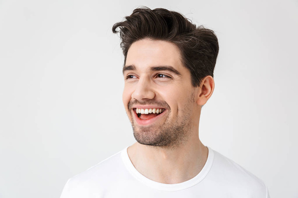 Happy young excited emotional man posing isolated over white wall background. - Foto, imagen