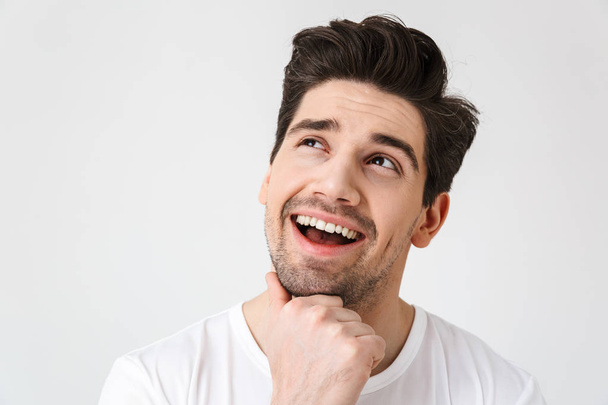 Happy young excited emotional man posing isolated over white wall background. - Zdjęcie, obraz